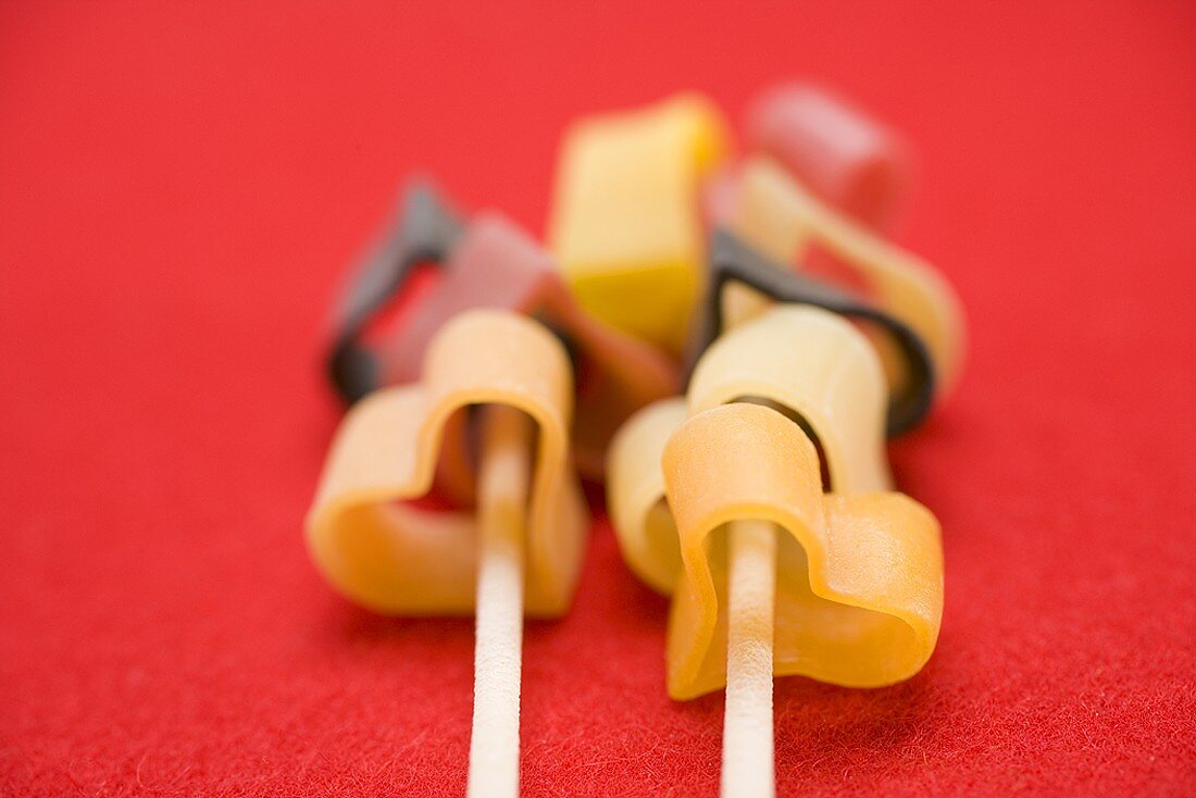 Heart-shaped pasta on red background