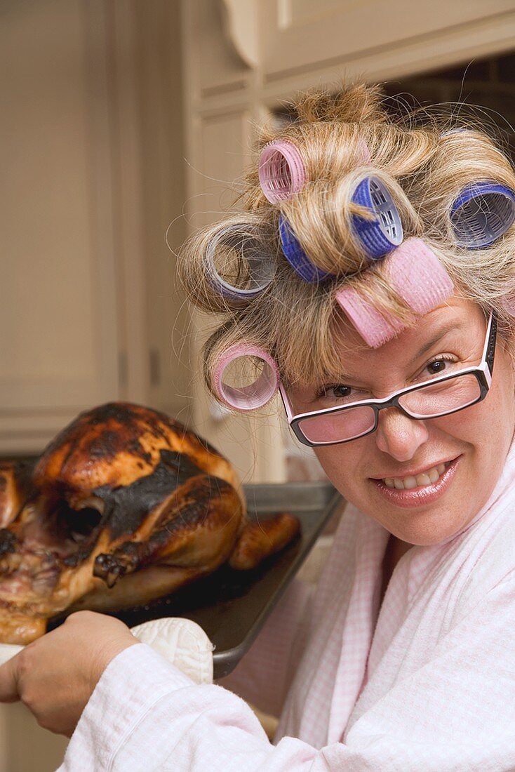 Housewife with burnt turkey in roasting tin