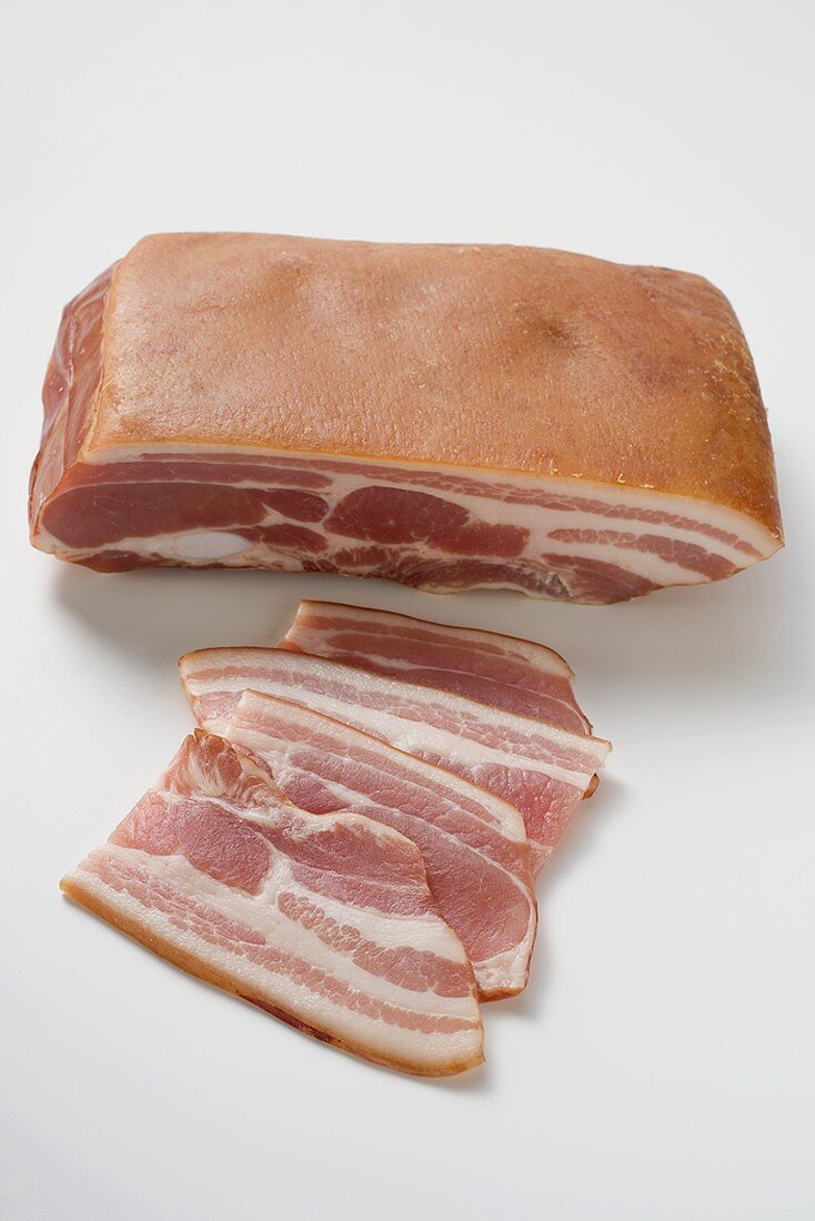 A piece of bacon and a few slices of bacon