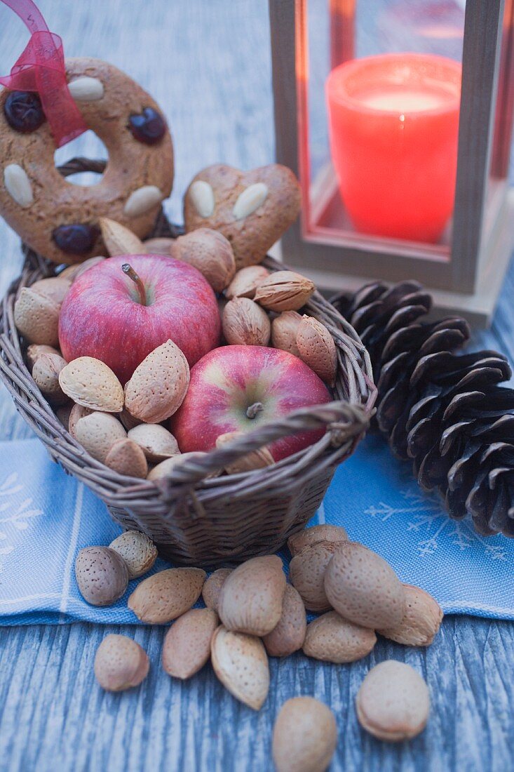 Christmas decoration with apples, nuts, candle & gingerbread