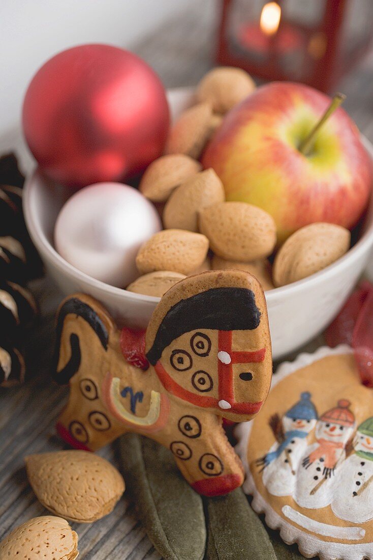 Gingerbread tree ornaments, almonds, apple, Christmas baubles
