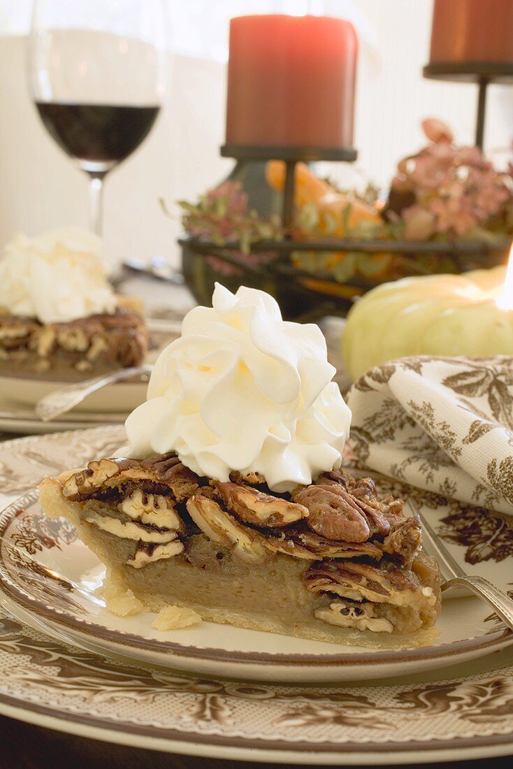 Piece of pecan pie with cream for Thanksgiving