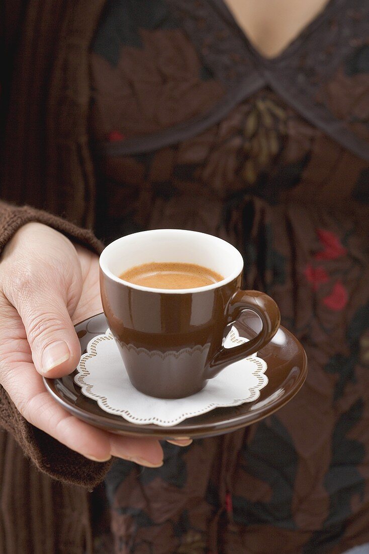Woman holding cup of espresso