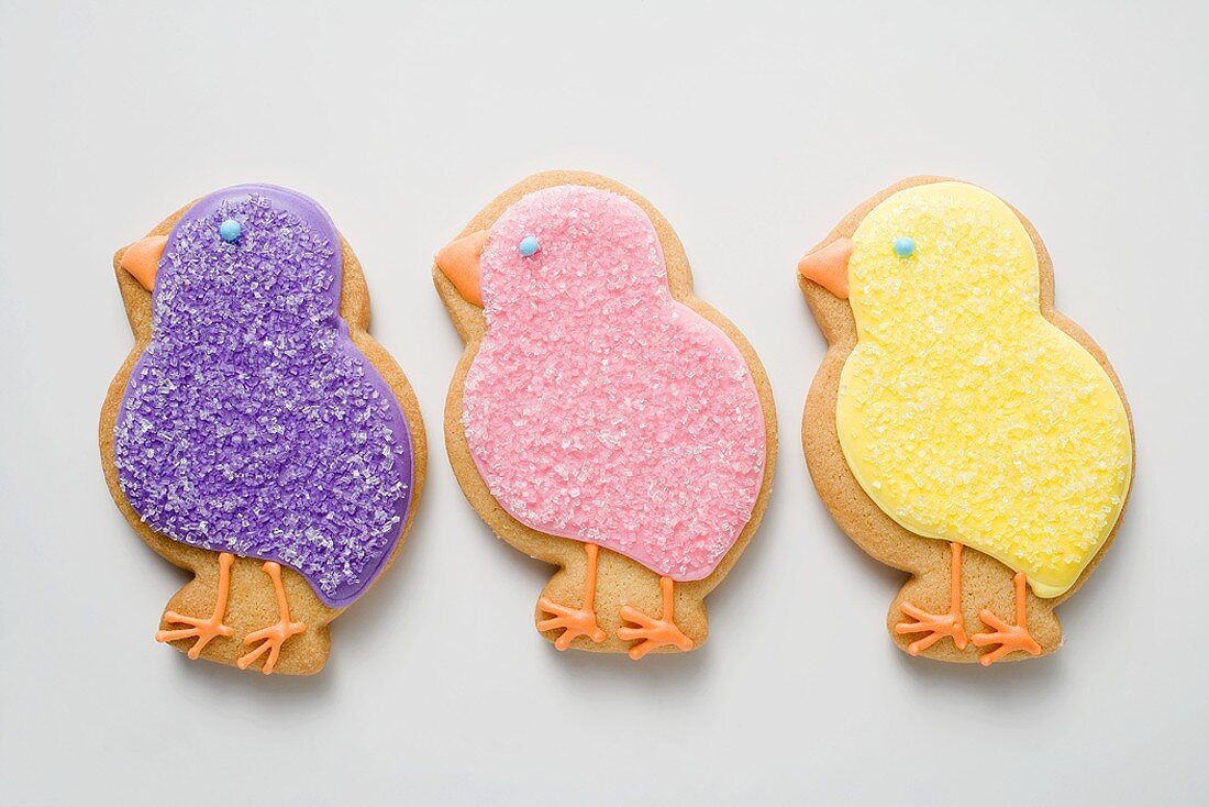 Three Easter biscuits (purple, pink, yellow chicks)