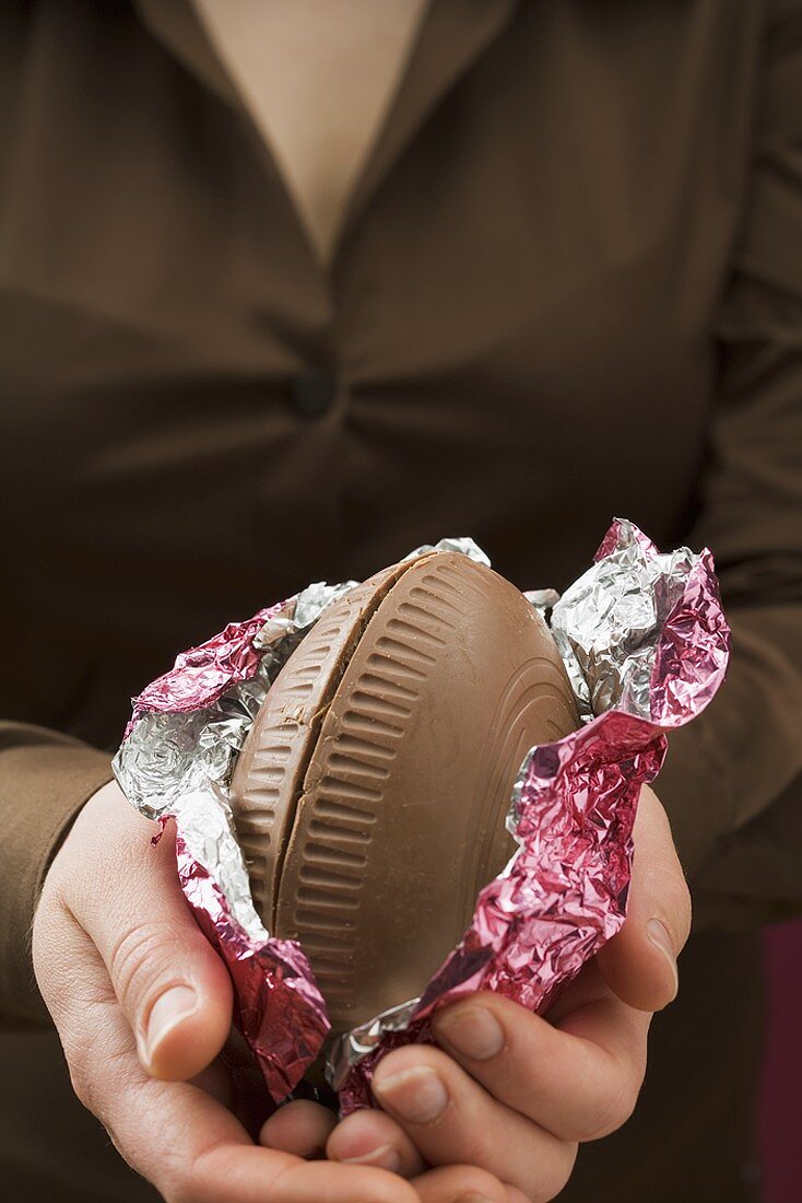 Woman holding a chocolate Easter egg