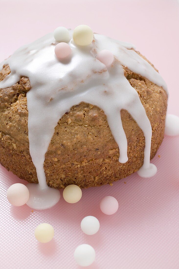 Cake decorated with glacé icing and sugar balls