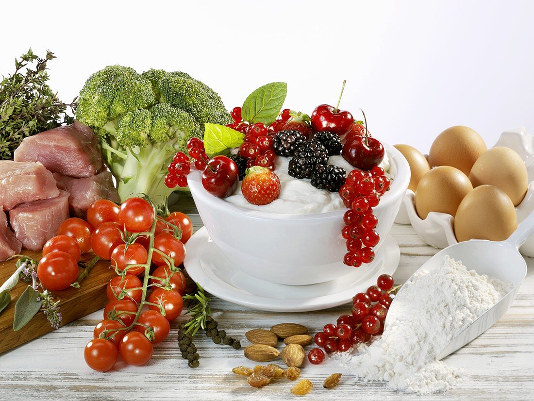 Still life with berries, vegetables, meat, flour, eggs