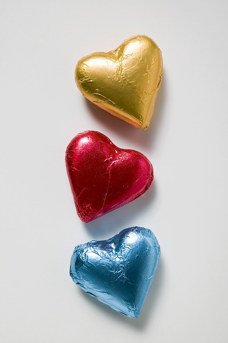 Three chocolate hearts in coloured foil