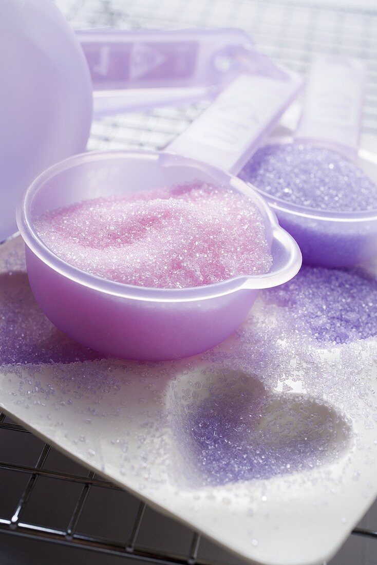 Coloured sugar for decorating biscuits on baking tin