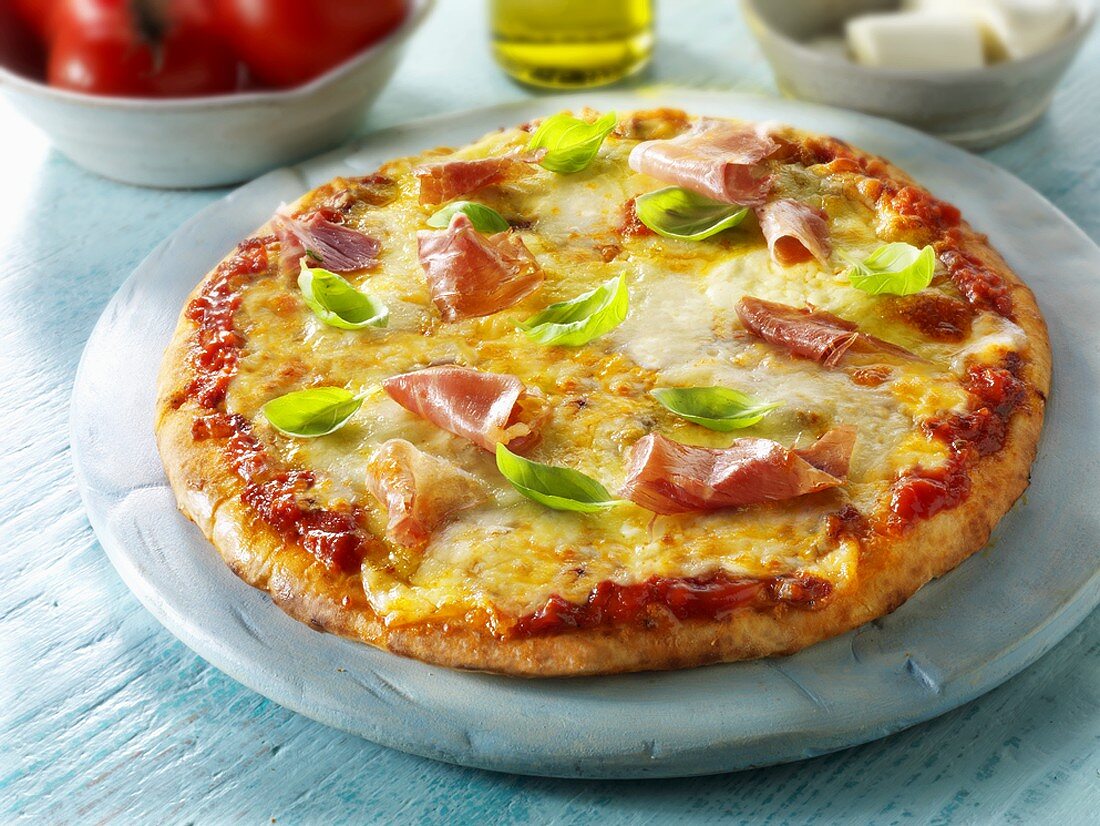 Pizza with ham and basil