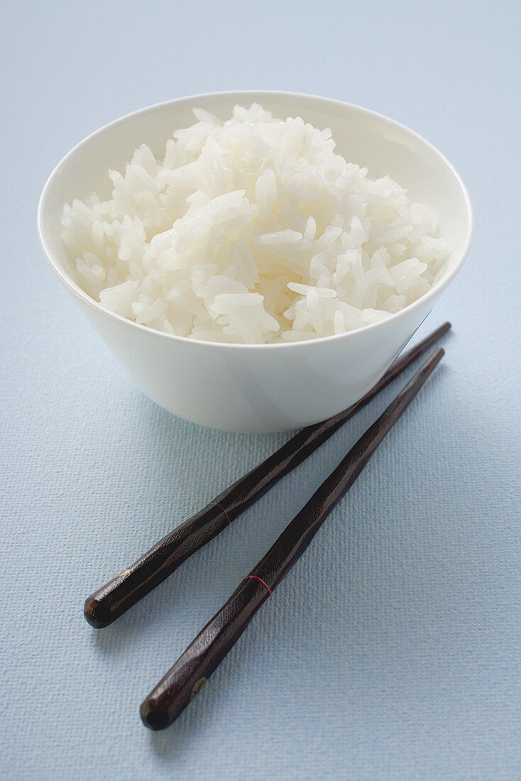 Bowl of rice, chopsticks beside it