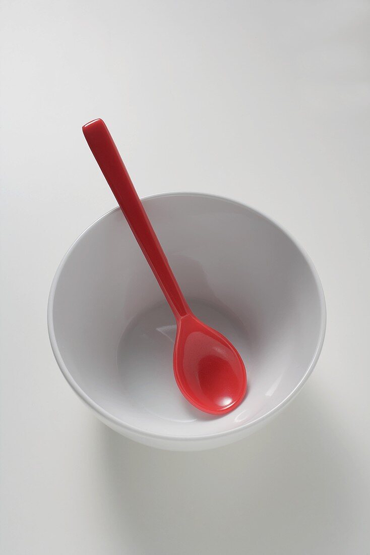 Red spoon in white bowl