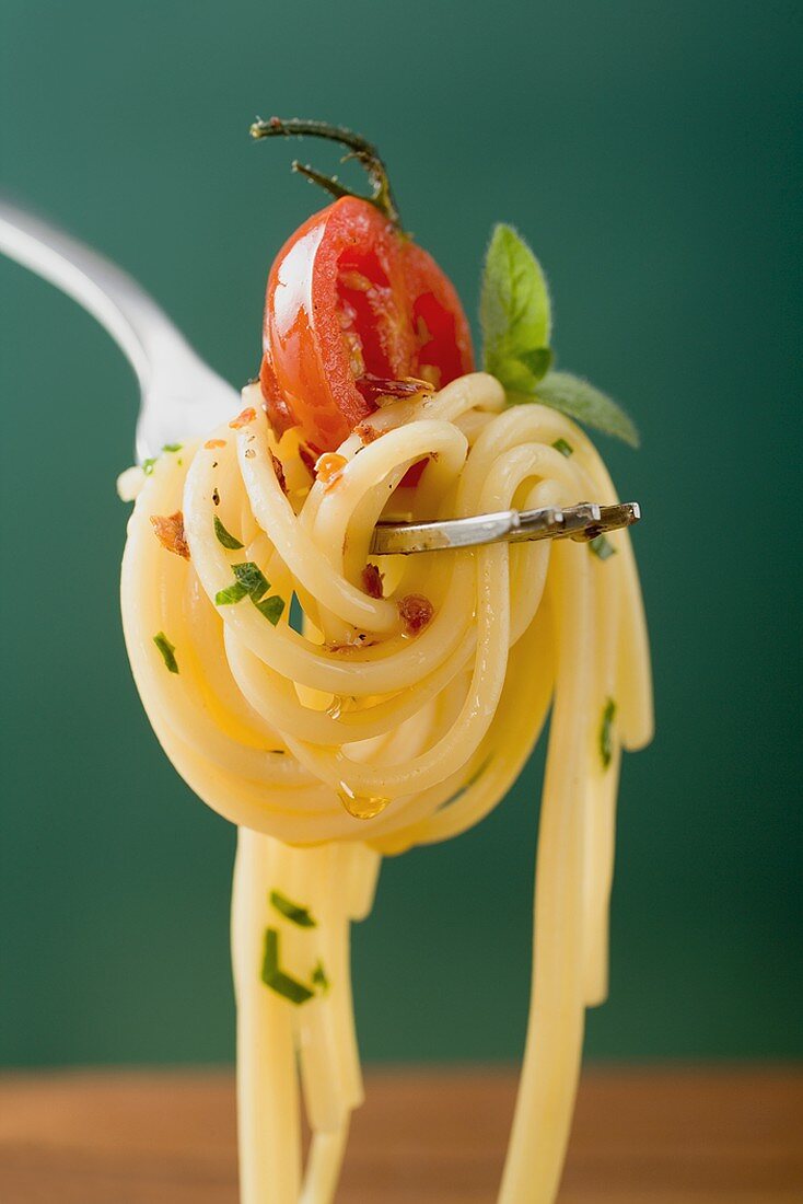 Spaghetti with cherry tomato on fork