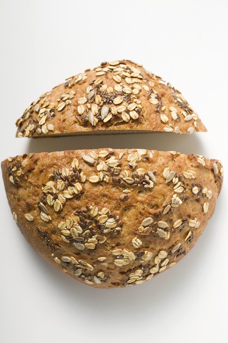Wholemeal bread with pumpkin seeds, cut in two