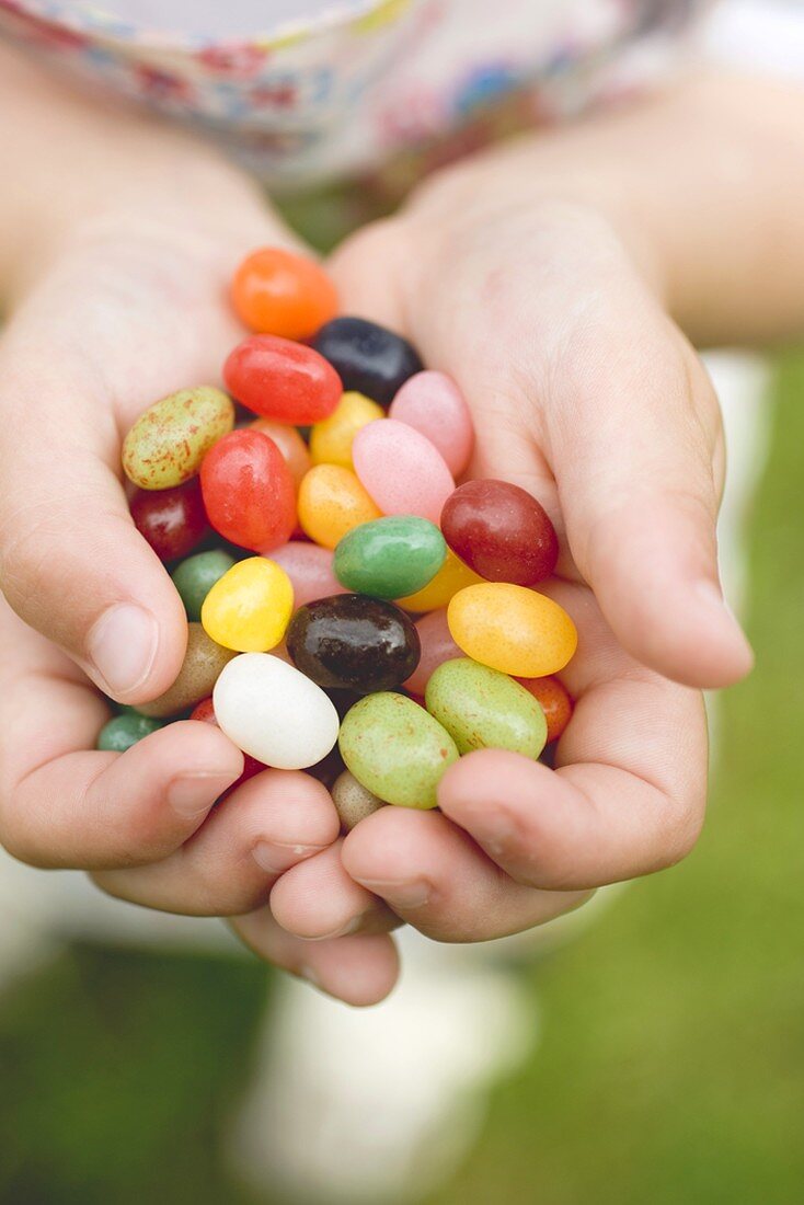 Child's hands holding coloured sugar eggs