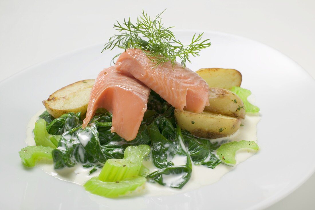 Salmon trout fillet with spinach, celery and potatoes