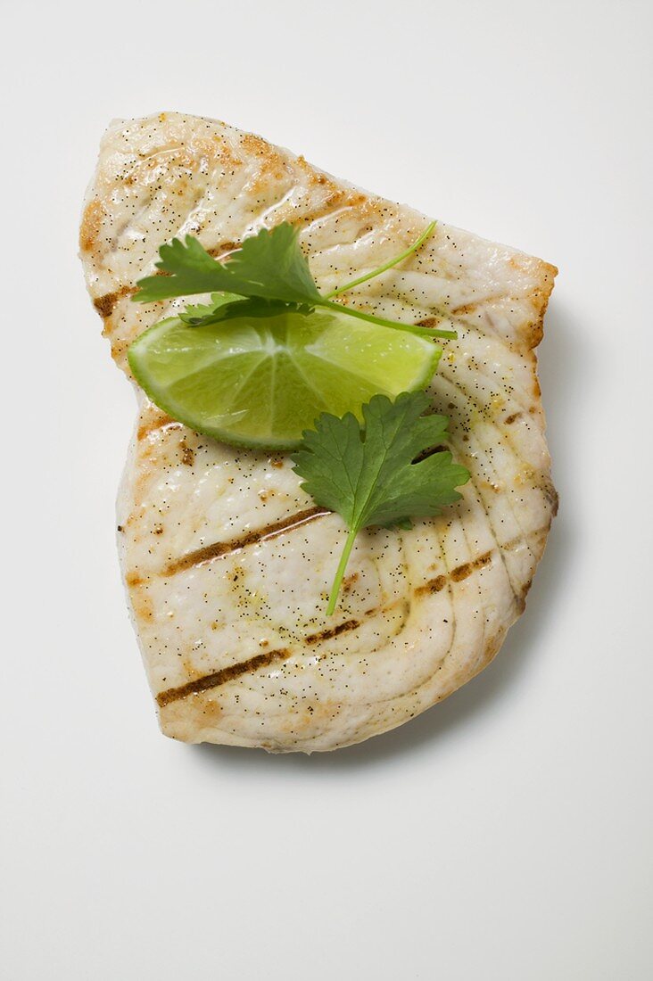 Grilled swordfish steak with lime and coriander leaves