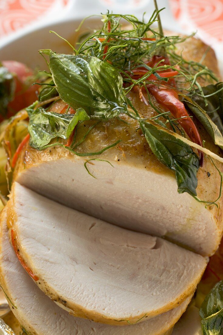 Roast turkey with chillies and herbs, partly carved