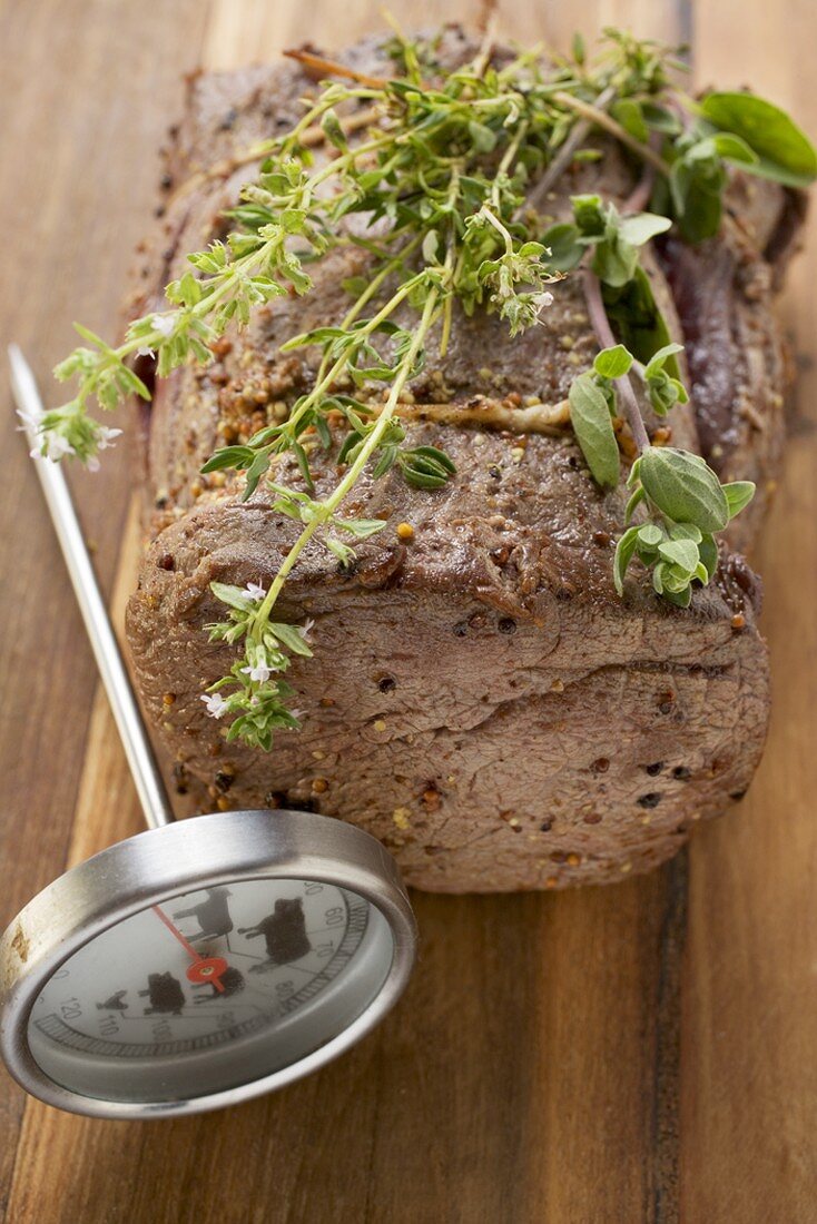 Roast beef with herbs, meat thermometer