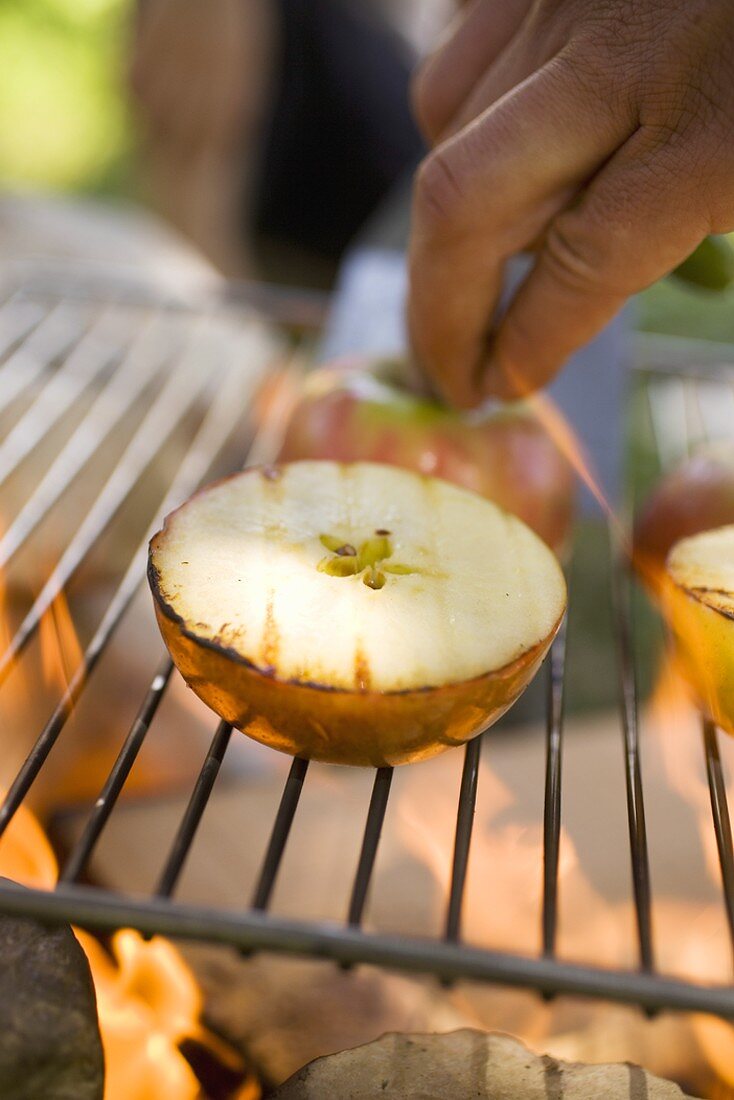 Grilled apples on barbecue grill rack