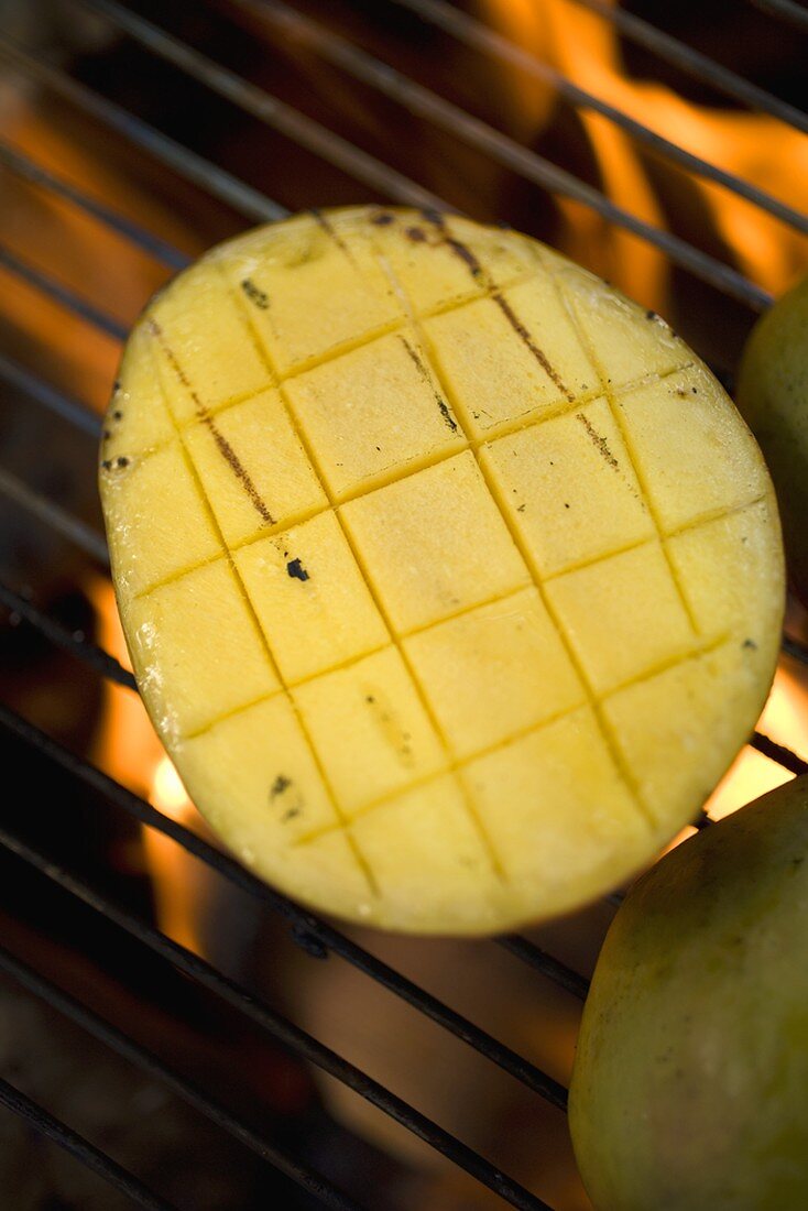 Mango on barbecue grill rack