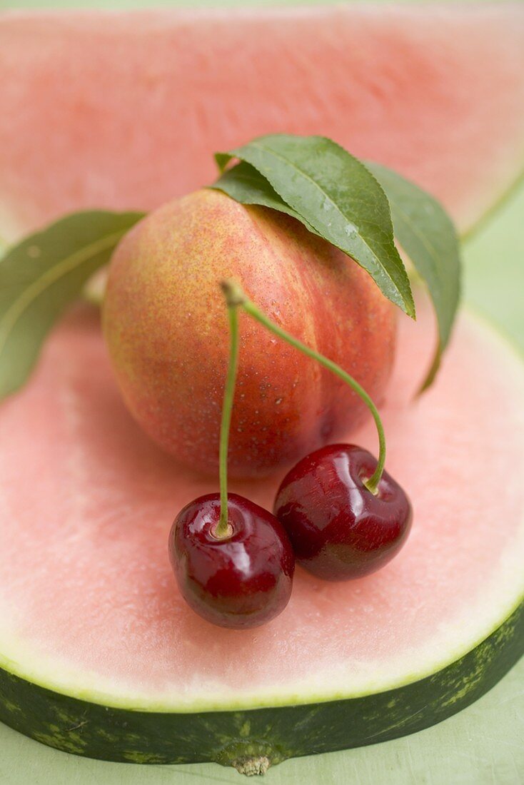 Nectarine with leaves, watermelon and cherries