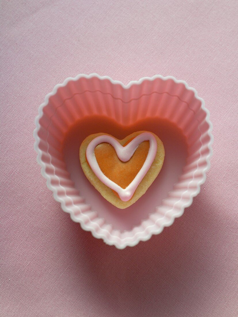 Heart-shaped biscuit in pink baking dish