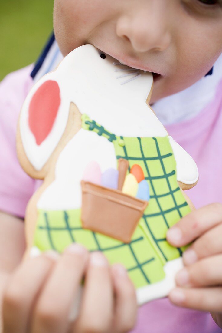 Child biting into Easter Bunny biscuit