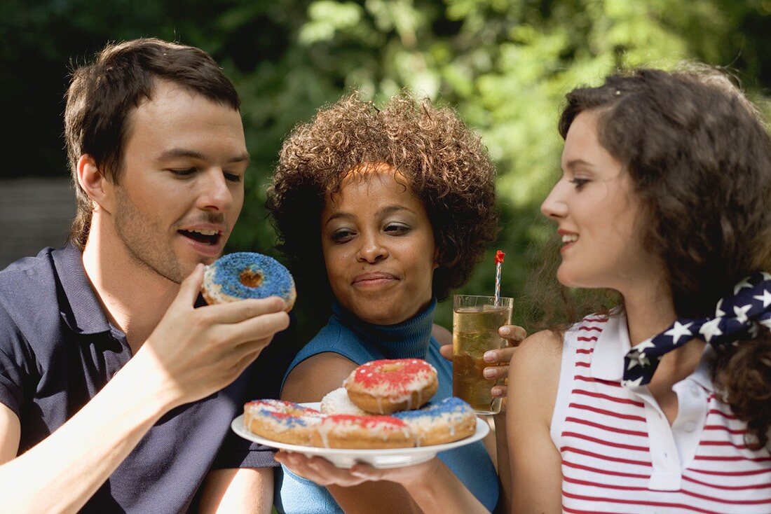 Young people with doughnuts & iced tea on the 4th of July (USA)