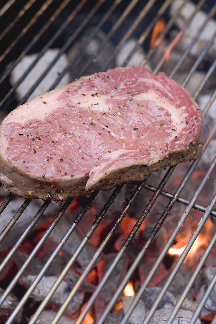 Raw beef steak on a barbecue