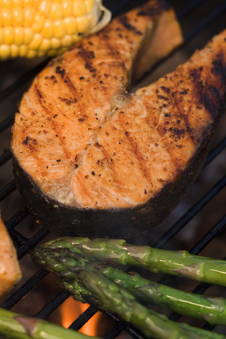 Salmon steak and vegetables on a barbecue