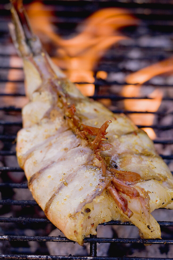 Butterflied king prawn on a barbecue