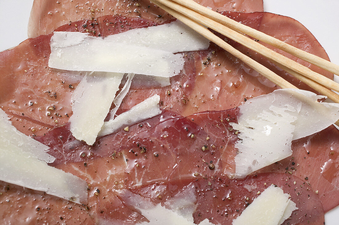 Beef carpaccio with Parmesan and grissini (close-up)