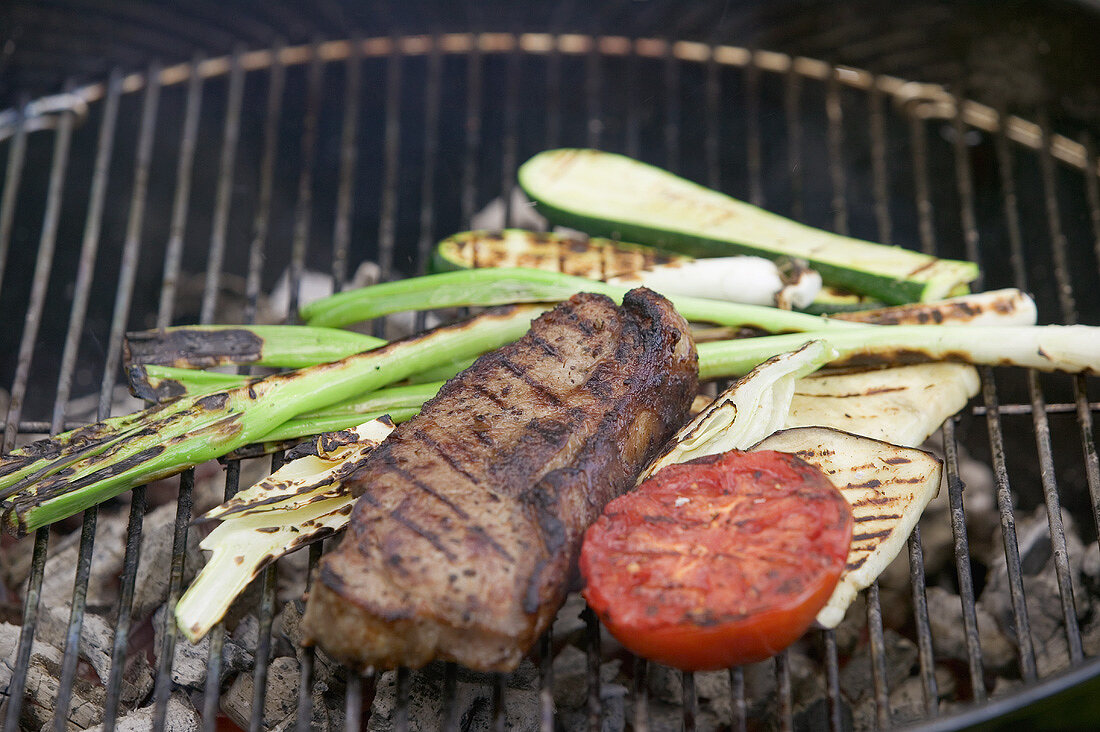 Beef steak and vegetables on a barbecue