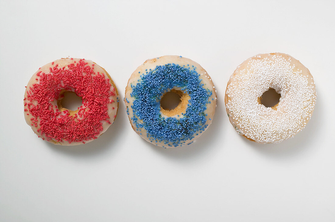 Three doughnuts with sprinkles (red, blue, white)
