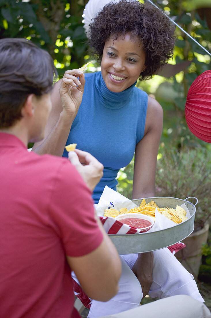 Young people with snacks at a 4th of July garden party (USA)