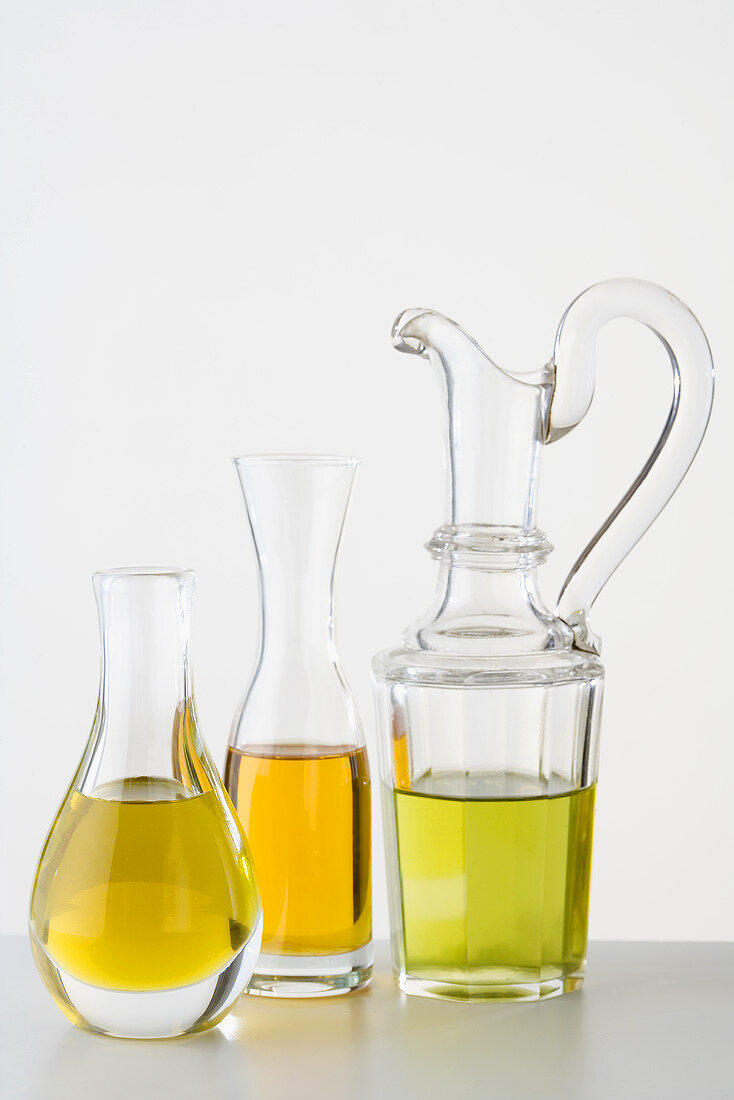 Three different types of oil in carafes