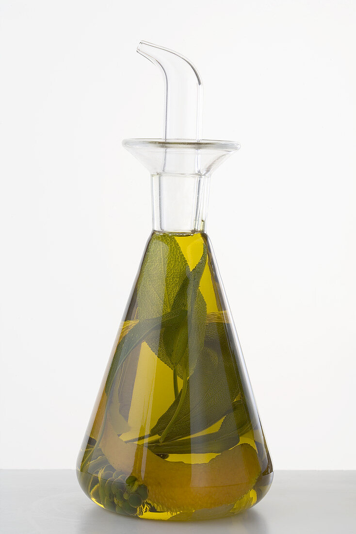 Herb oil with lemon peel in a bottle