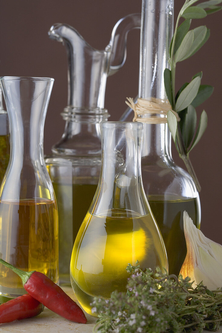 Various types of oil in carafes and bottles