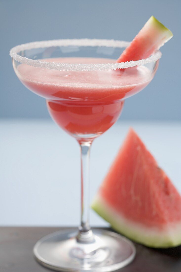 Watermelon drink in a glass with a sugared rim