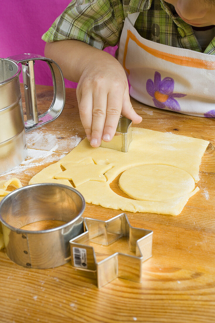 Child cutting out biscuits