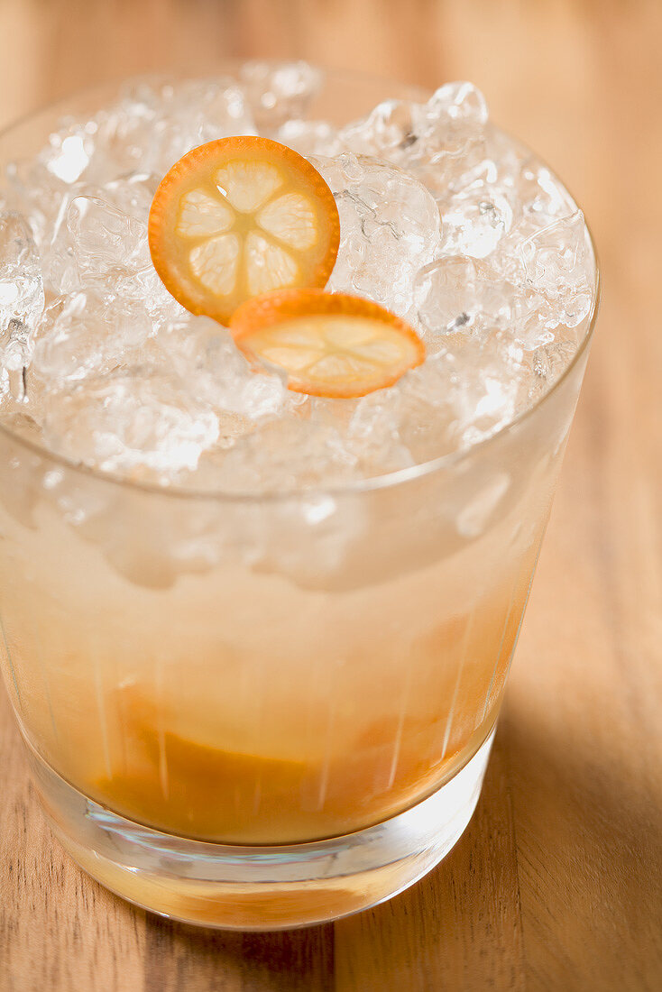 Cocktail with kumquats and ice cubes