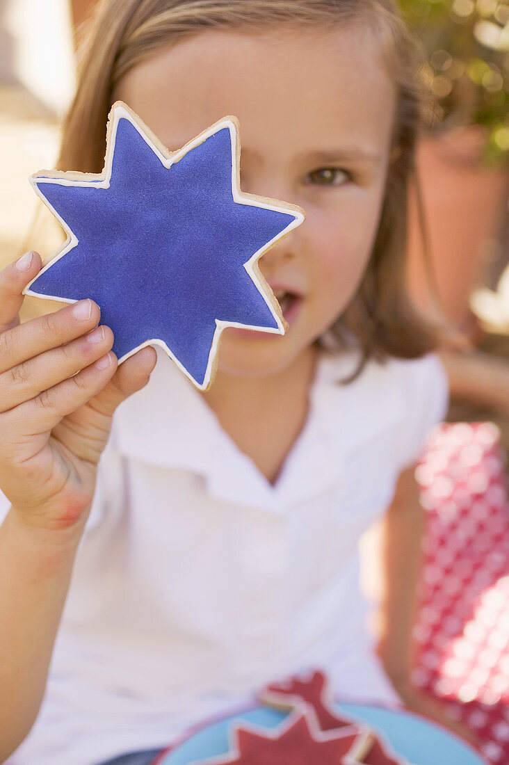 Small girl holding a star cookie (4th of July, USA)