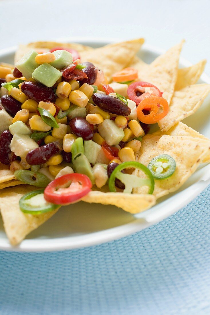 Nachos with beans, sweetcorn, avocado and chilli rings