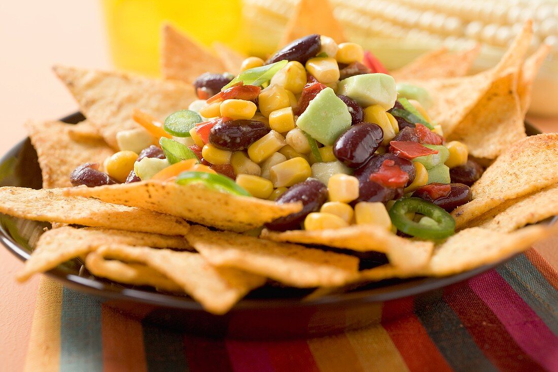 Nachos with beans, sweetcorn, avocado and chilli rings