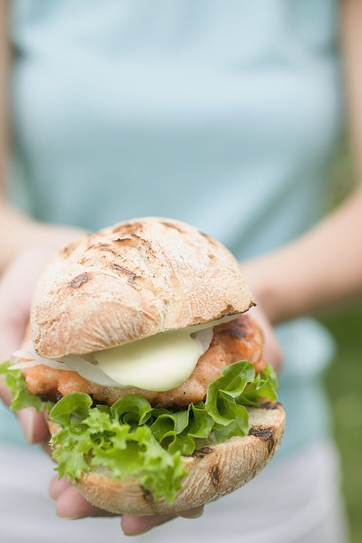 Woman holding chicken burger