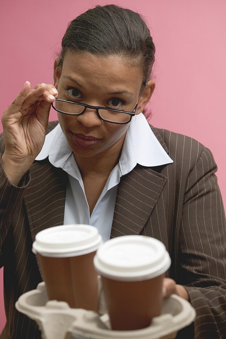 Businesswoman offering two cups of coffee