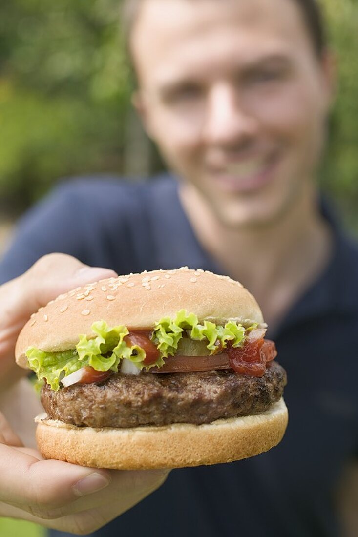 Man holding hamburger