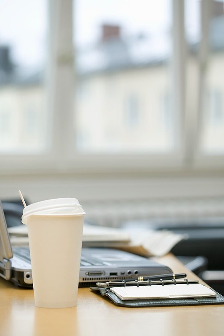 Coffee cup on desk in office