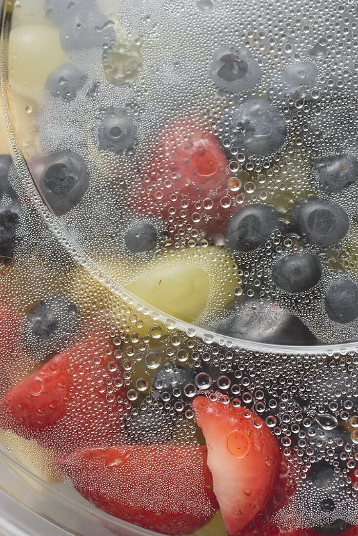 Fruit salad in plastic container (close-up)